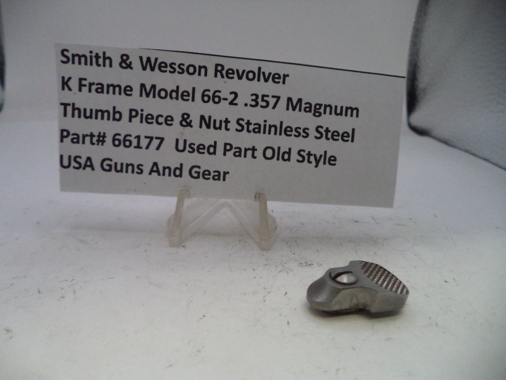 Small metal thumb piece and nut on a white surface with descriptive text card.
