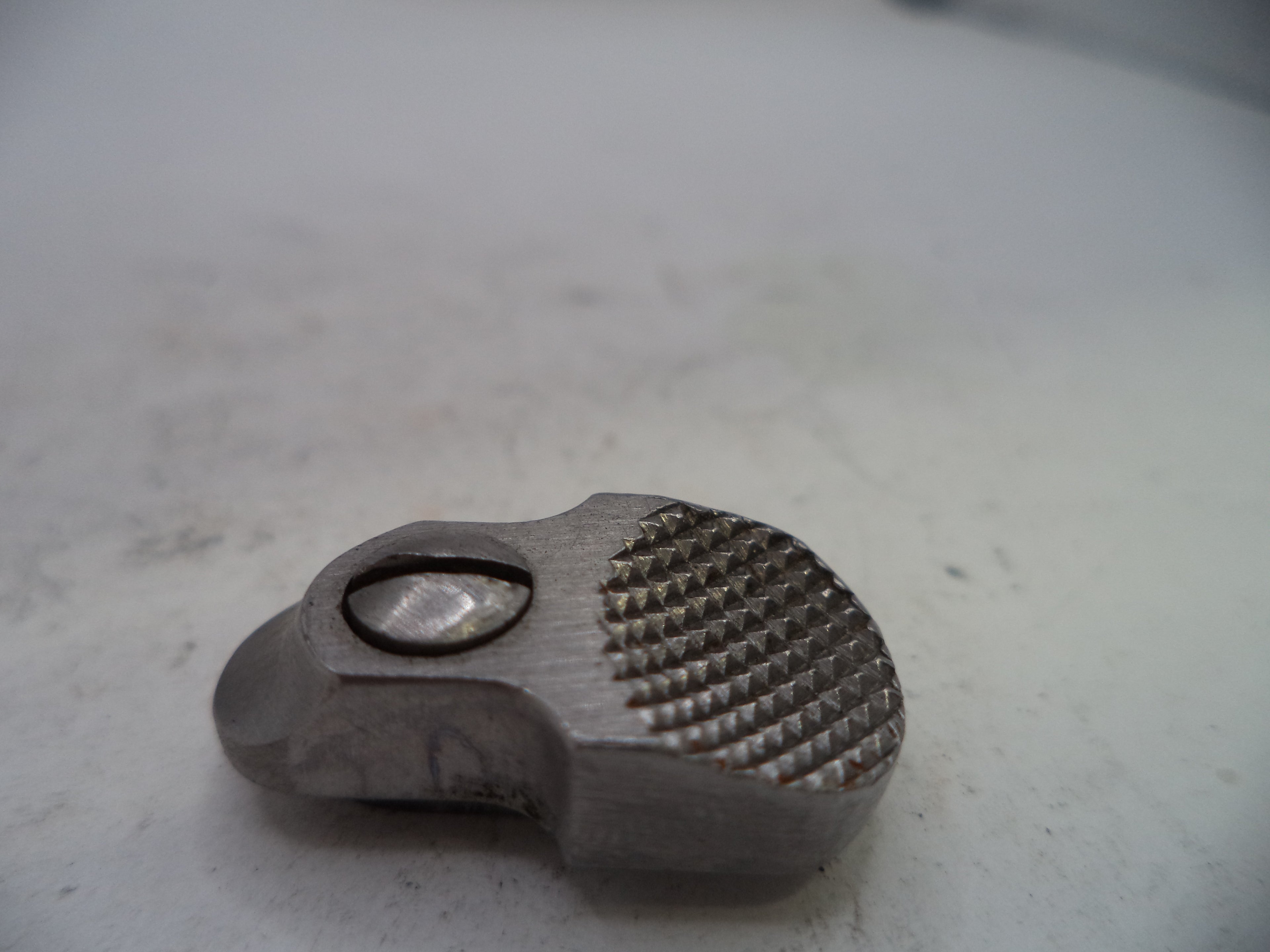 Metallic object with textured surface on a light gray background