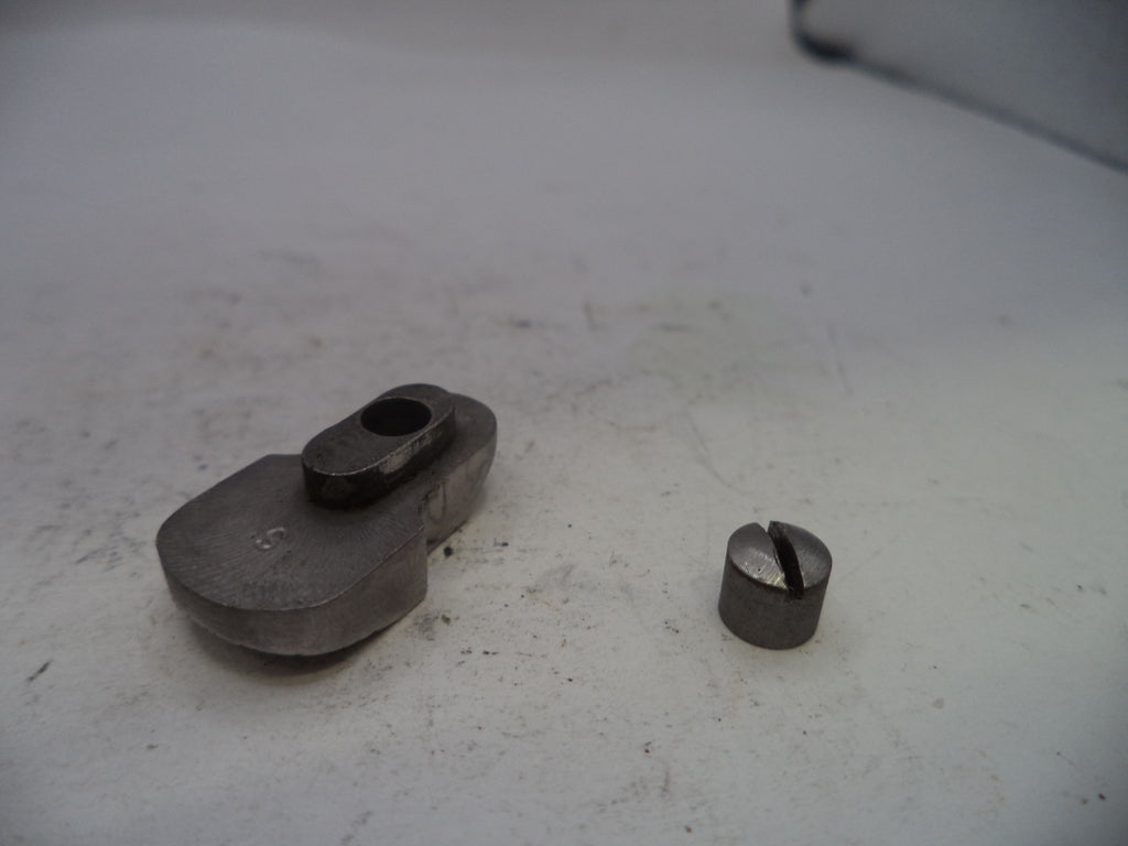 Two metal components on a white surface
