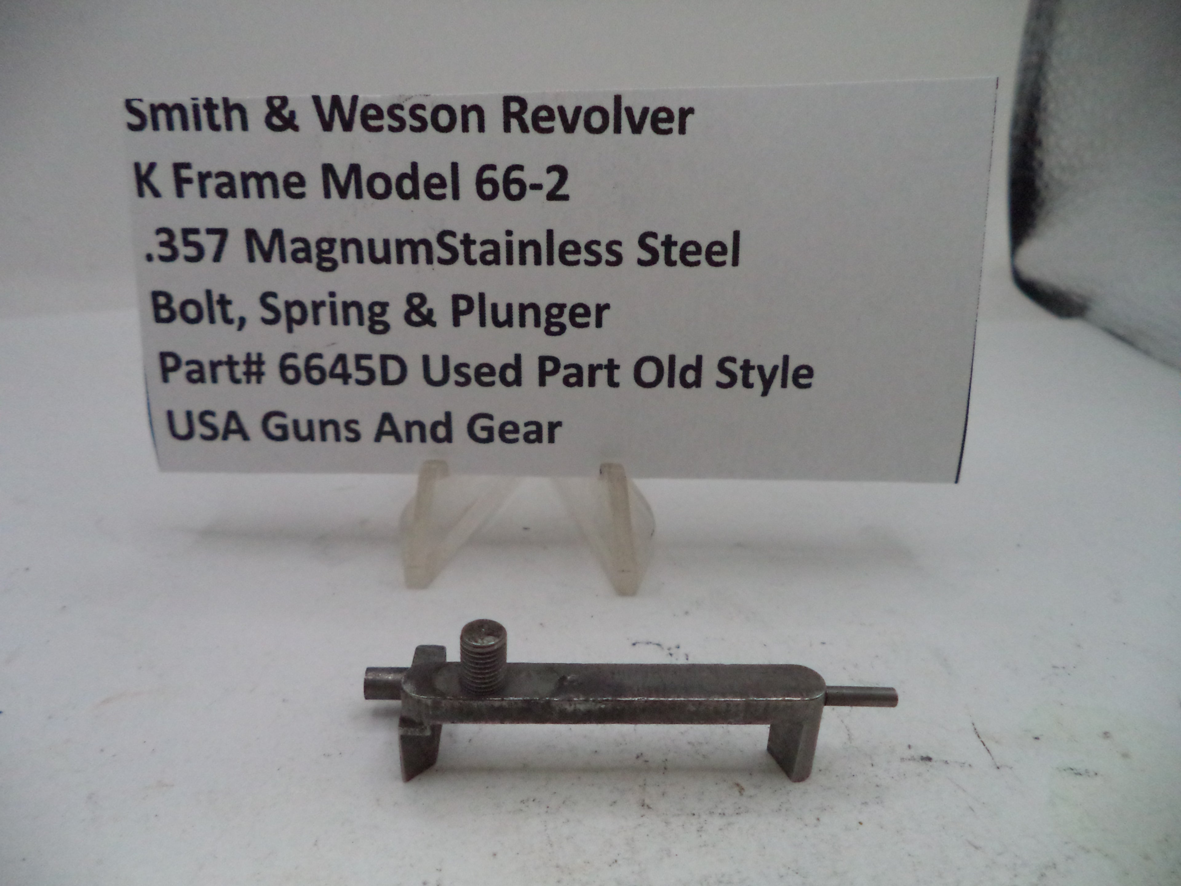 Smith & Wesson revolver part on a stand with descriptive card