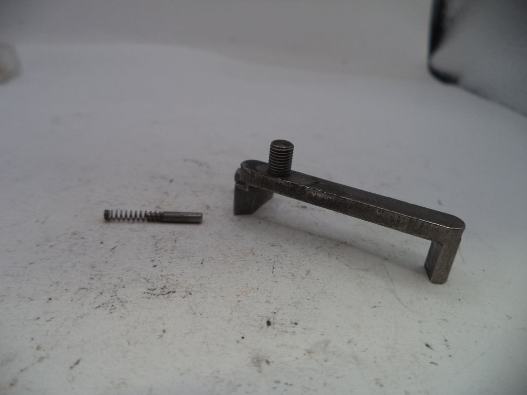 Metal lever and spring on a white surface