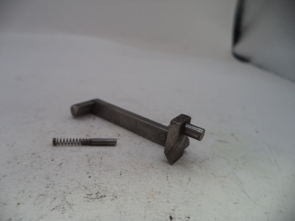 Metal lever and spring on a textured white surface