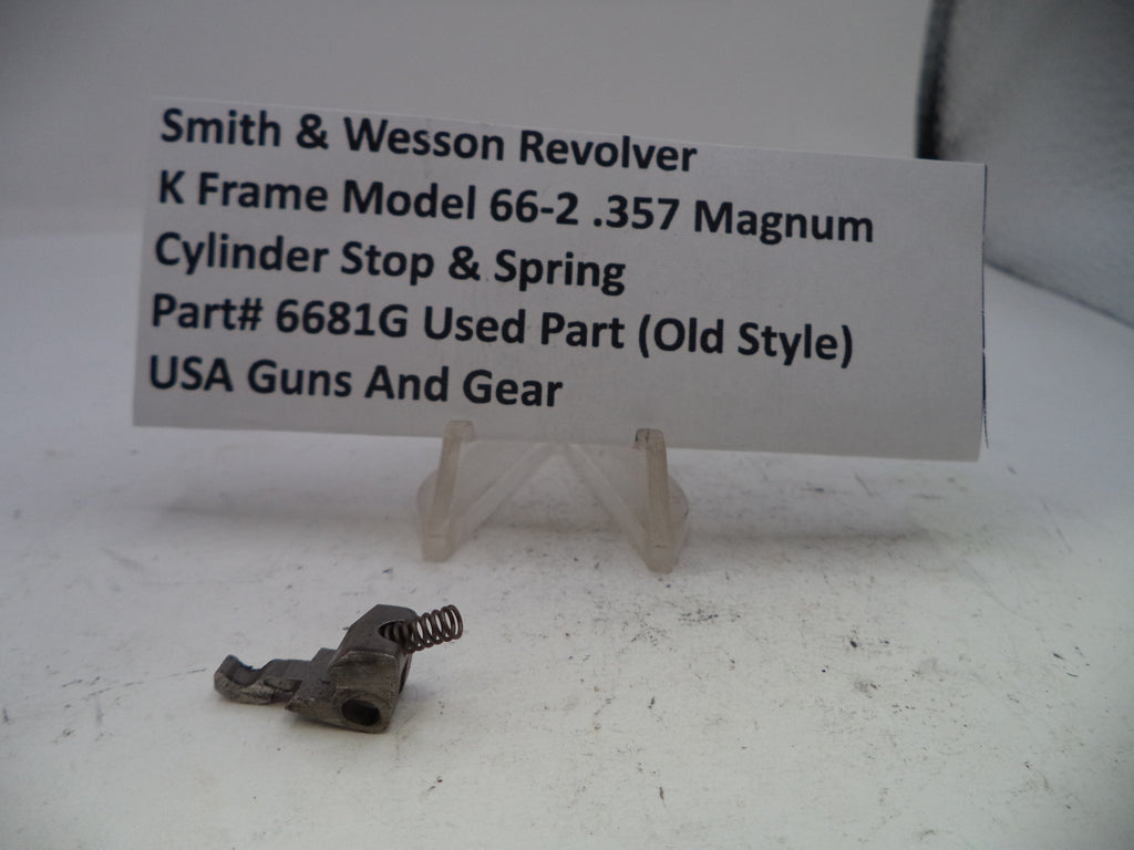 Smith & Wesson revolver cylinder stop and spring with a label on a white surface
