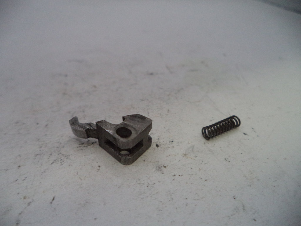 Mechanical component and spring on a white surface