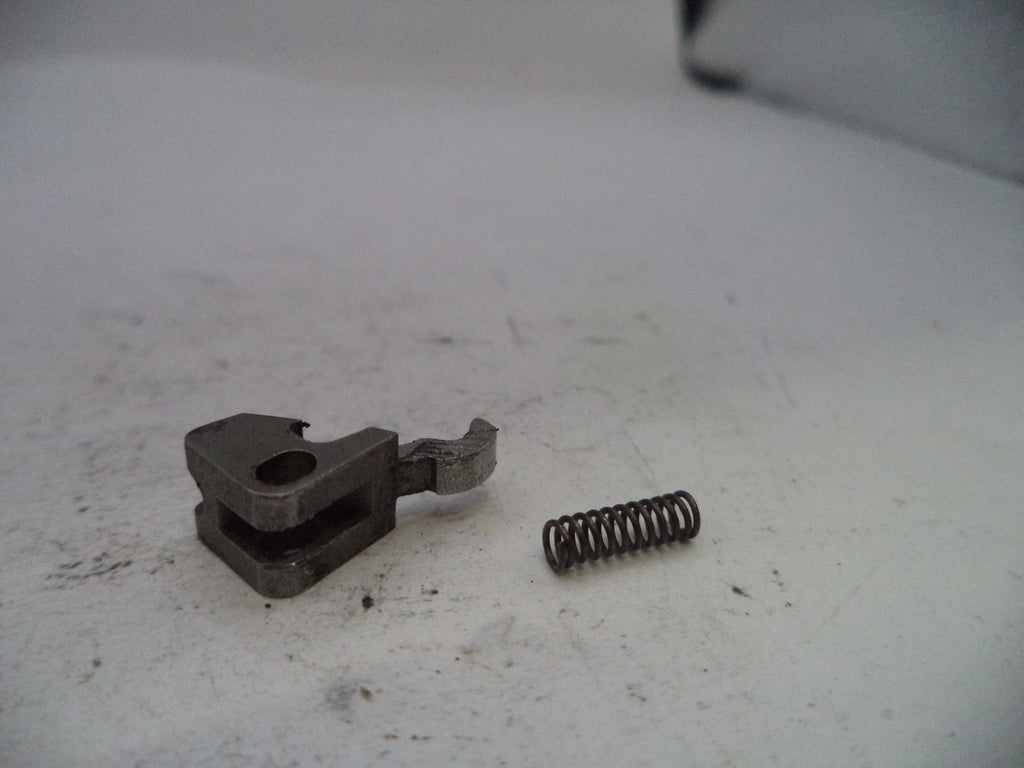 Metal component and spring on a white surface