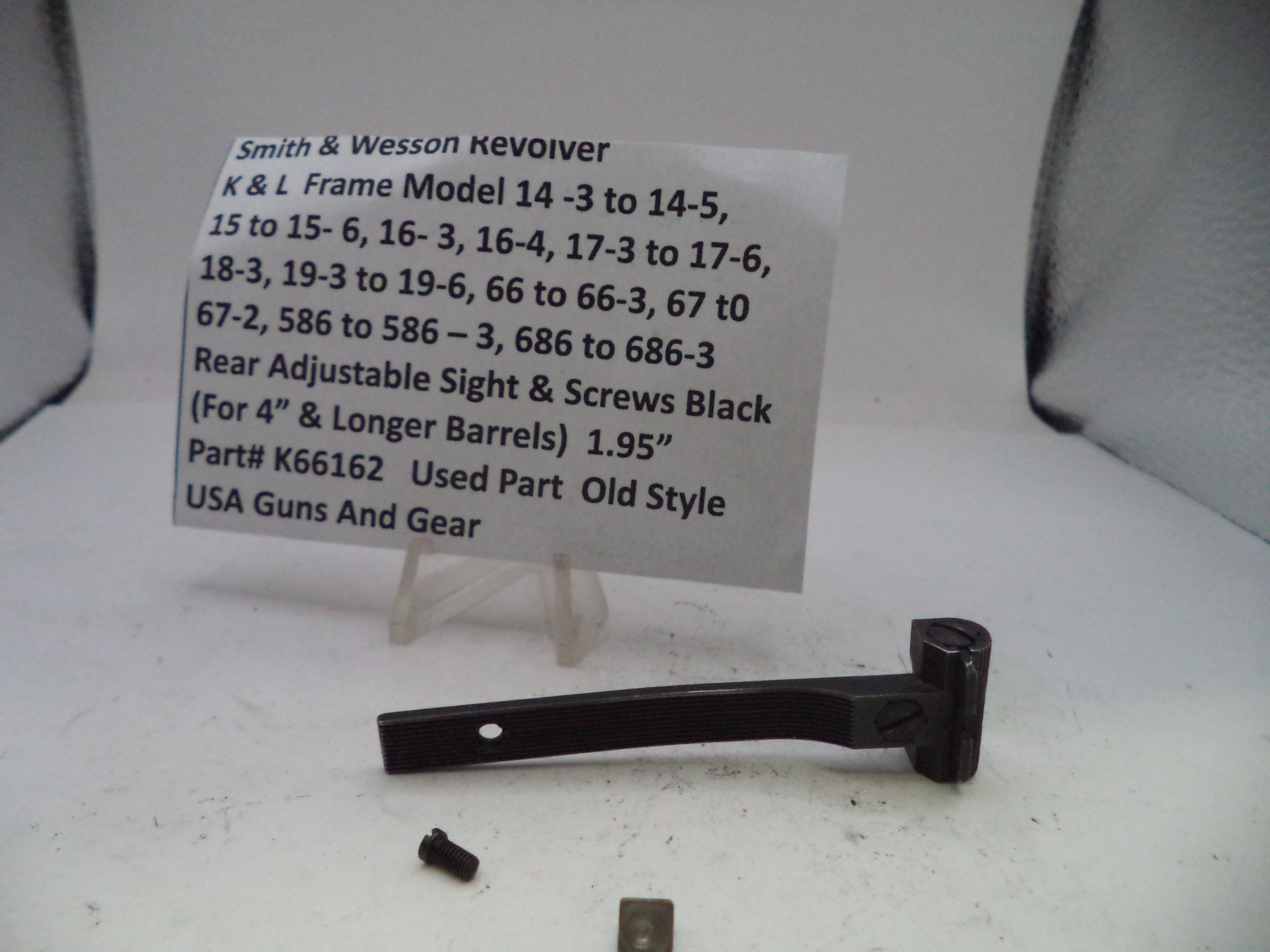 Black adjustable sight and screws with a label on a white background