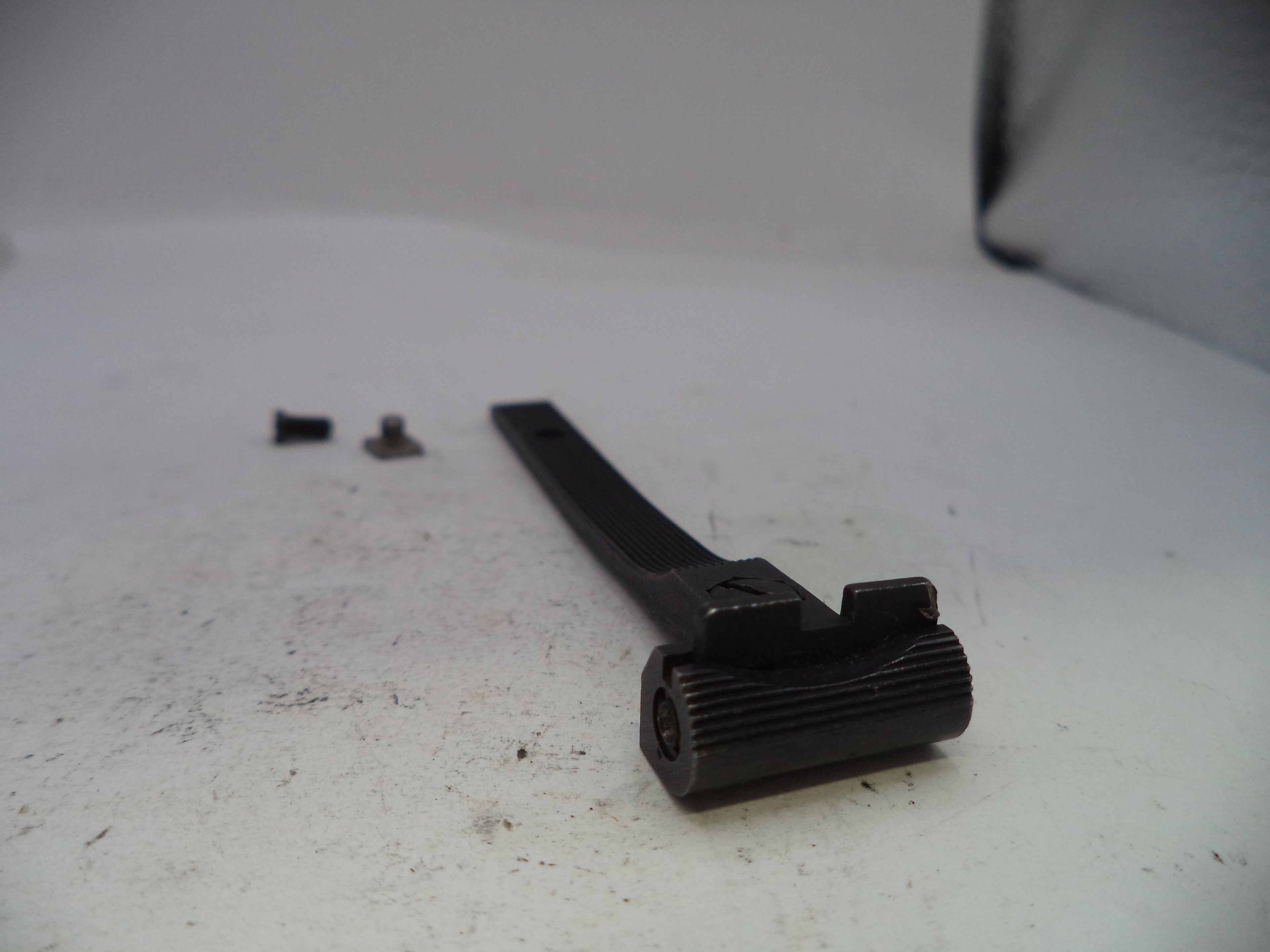 Black mechanical component on a white surface