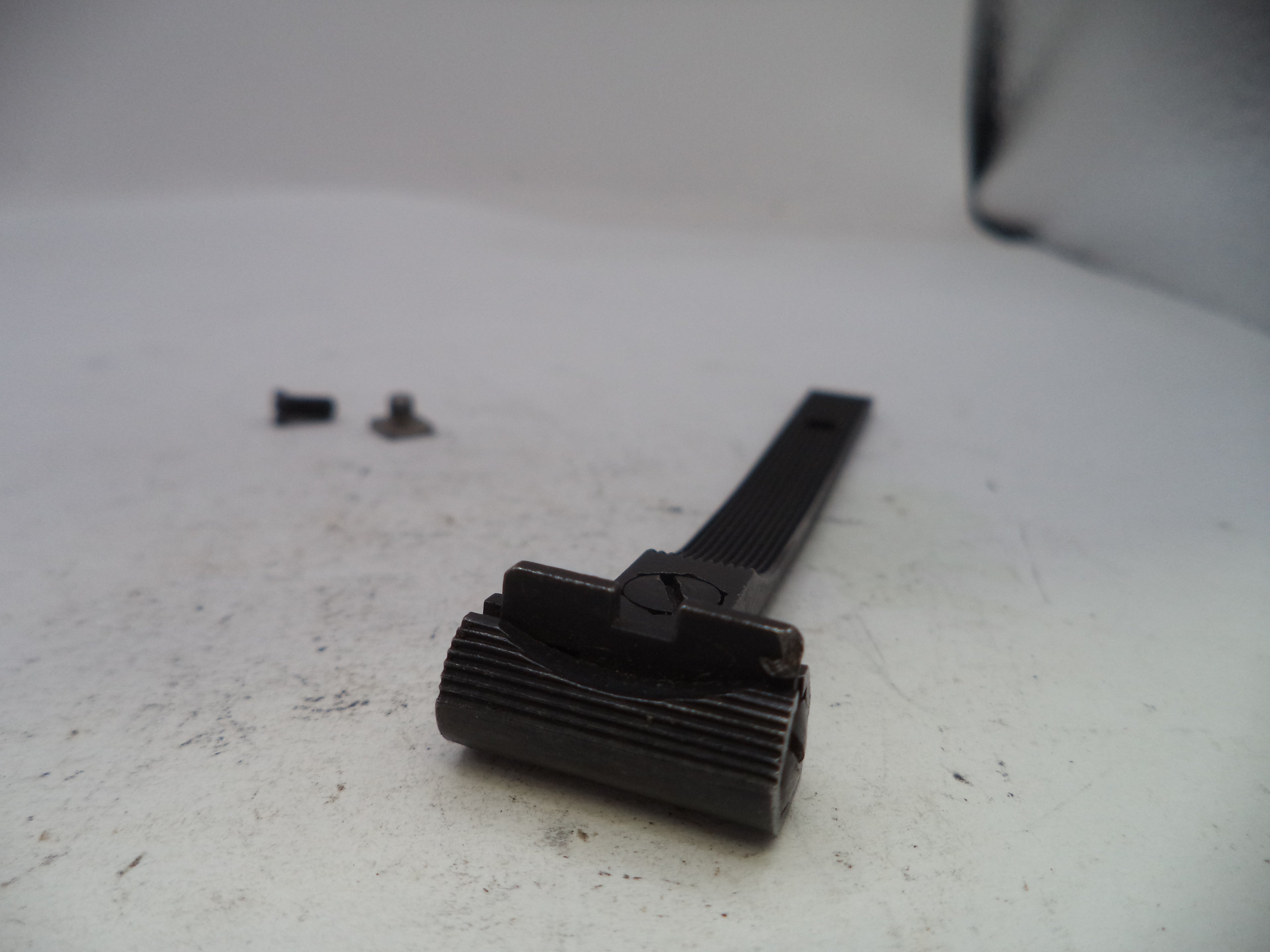 Black metal component on a white surface