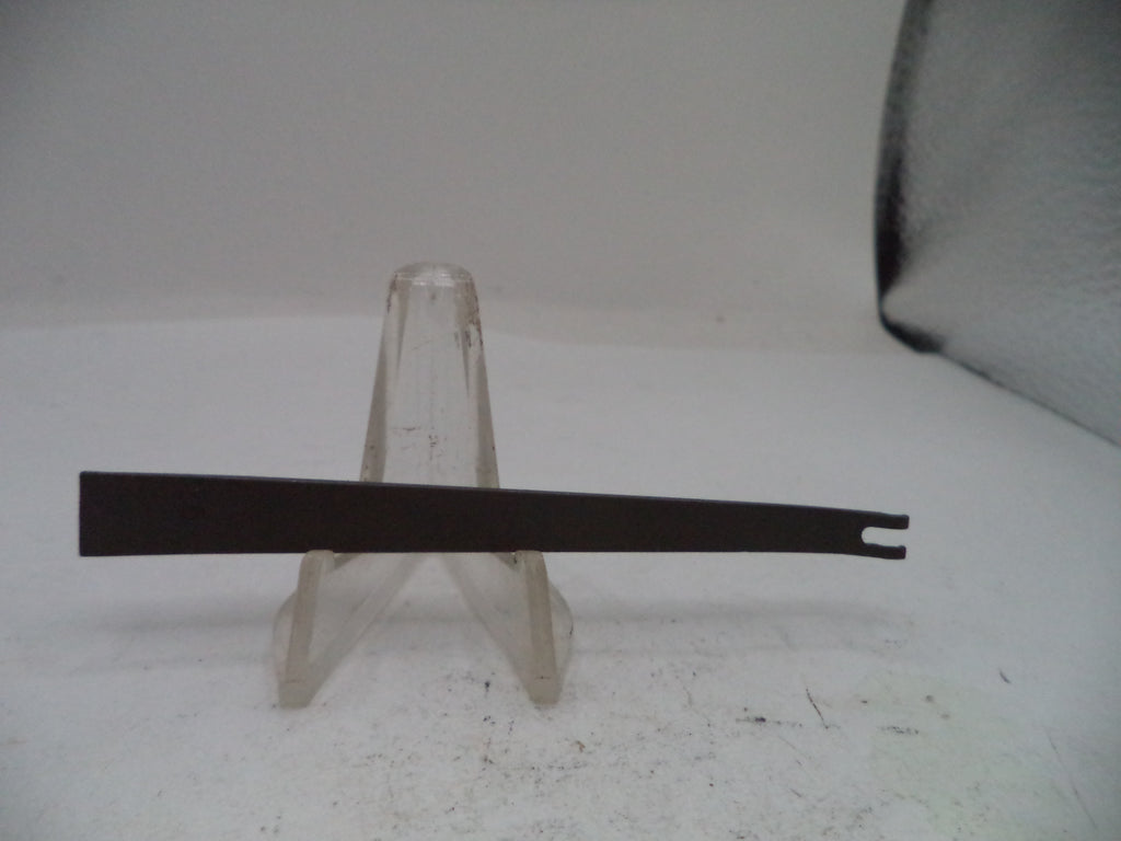 Black metal blade on a clear stand against a white background