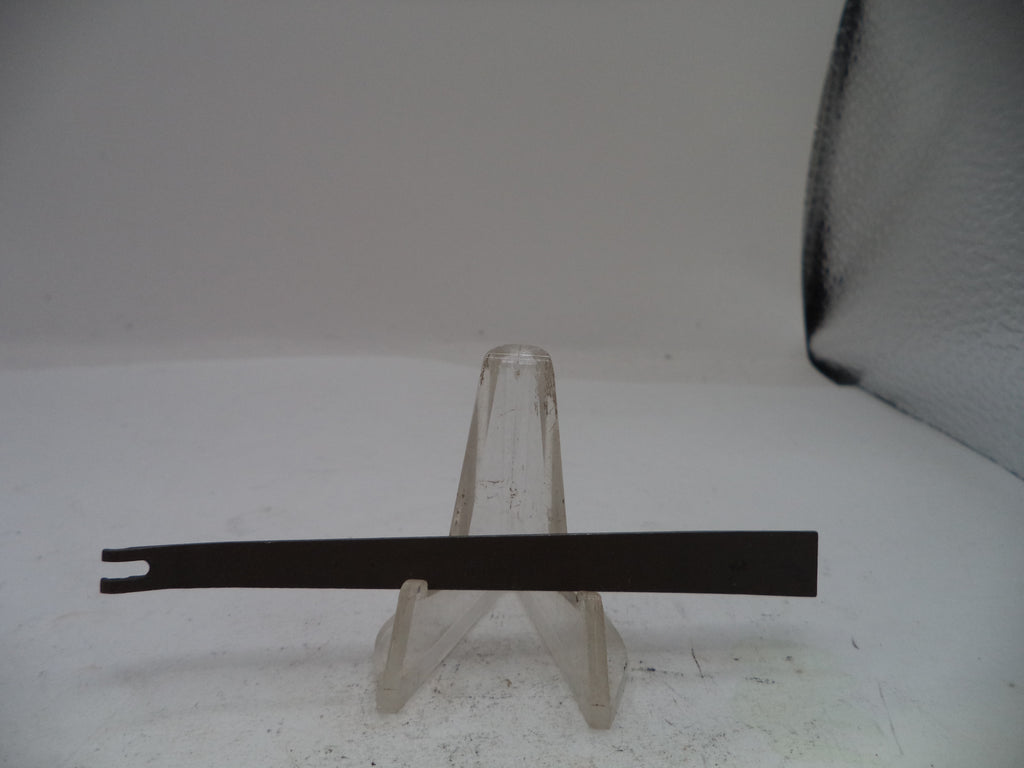 Black metal tool on a clear stand against a white background