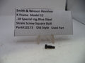 A small used blue steel screw for a Smith & Wesson revolver K frame, displayed on a clear plastic stand next to a white paper label with product details.