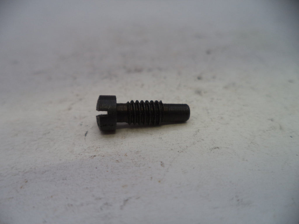 A small black metal threaded bolt or screw with a slotted head, resting on a light gray textured surface.