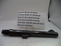 A black metal Smith & Wesson revolver barrel component displayed on a white surface with a product information card behind it.