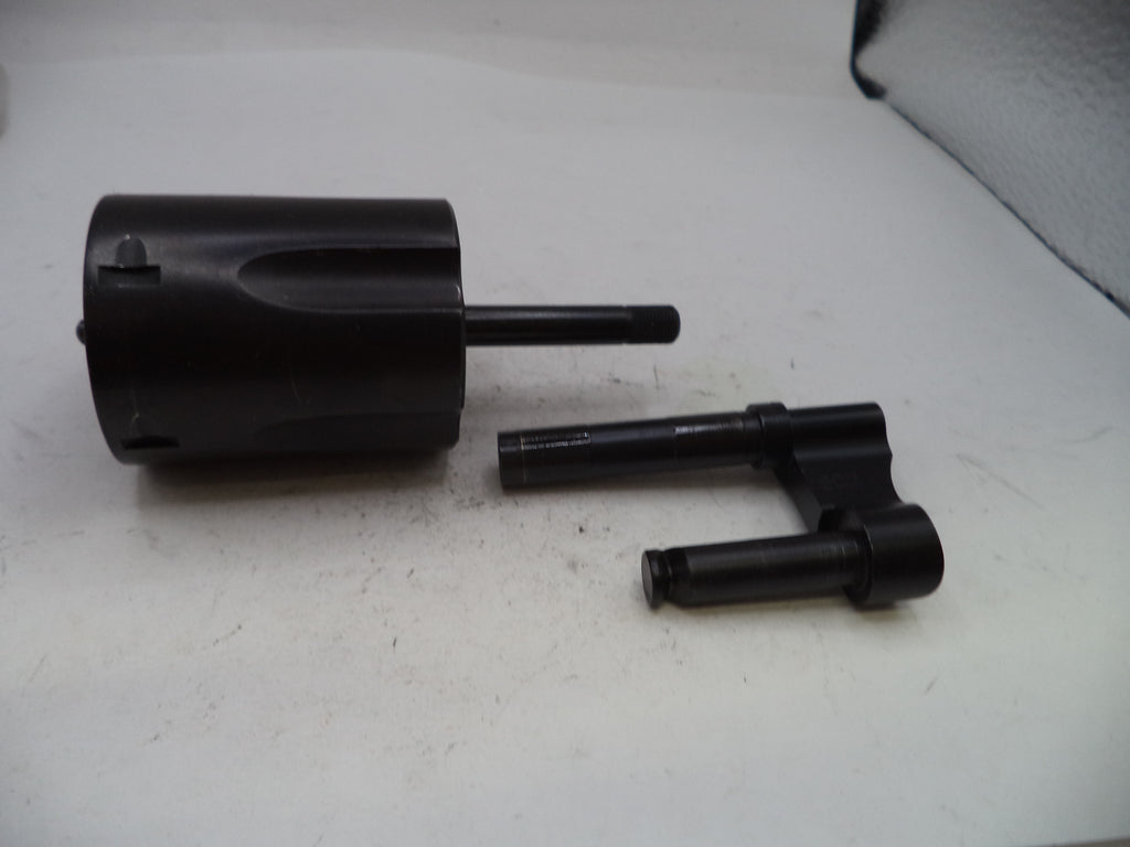 A set of black metal mechanical parts, including a cylindrical component with a protruding rod and a separate bracket-like piece, displayed on a white surface.