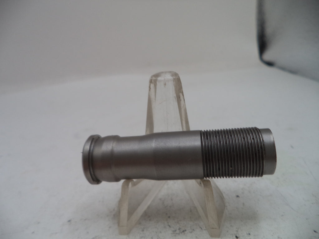 A metallic threaded pipe fitting or coupler shown horizontally on a clear plastic display stand against a plain light background.