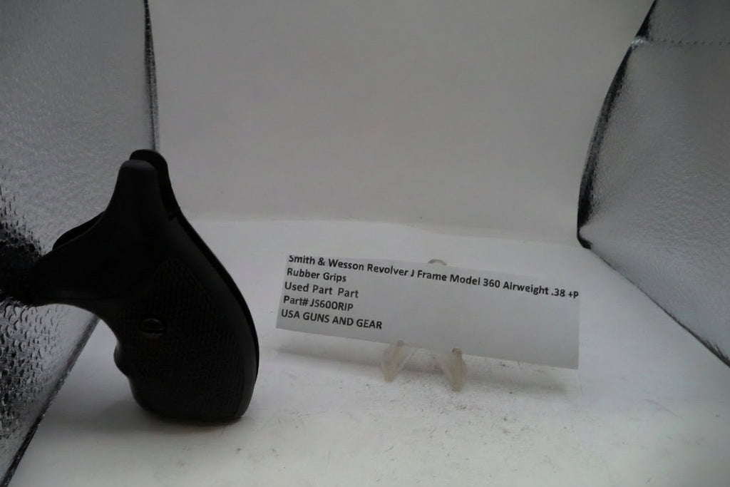 A black rubber grip replacement part for a Smith & Wesson Revolver J Frame Model 360 airsoft gun, displayed next to a white paper label card on a white surface.