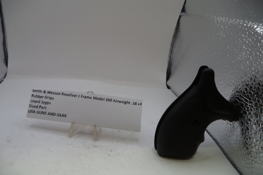 A black rubber grip replacement part for a Smith & Wesson Revolver J Frame Model 360 Airweight, displayed on a white surface next to a white product information card and a silver reflective sheet.