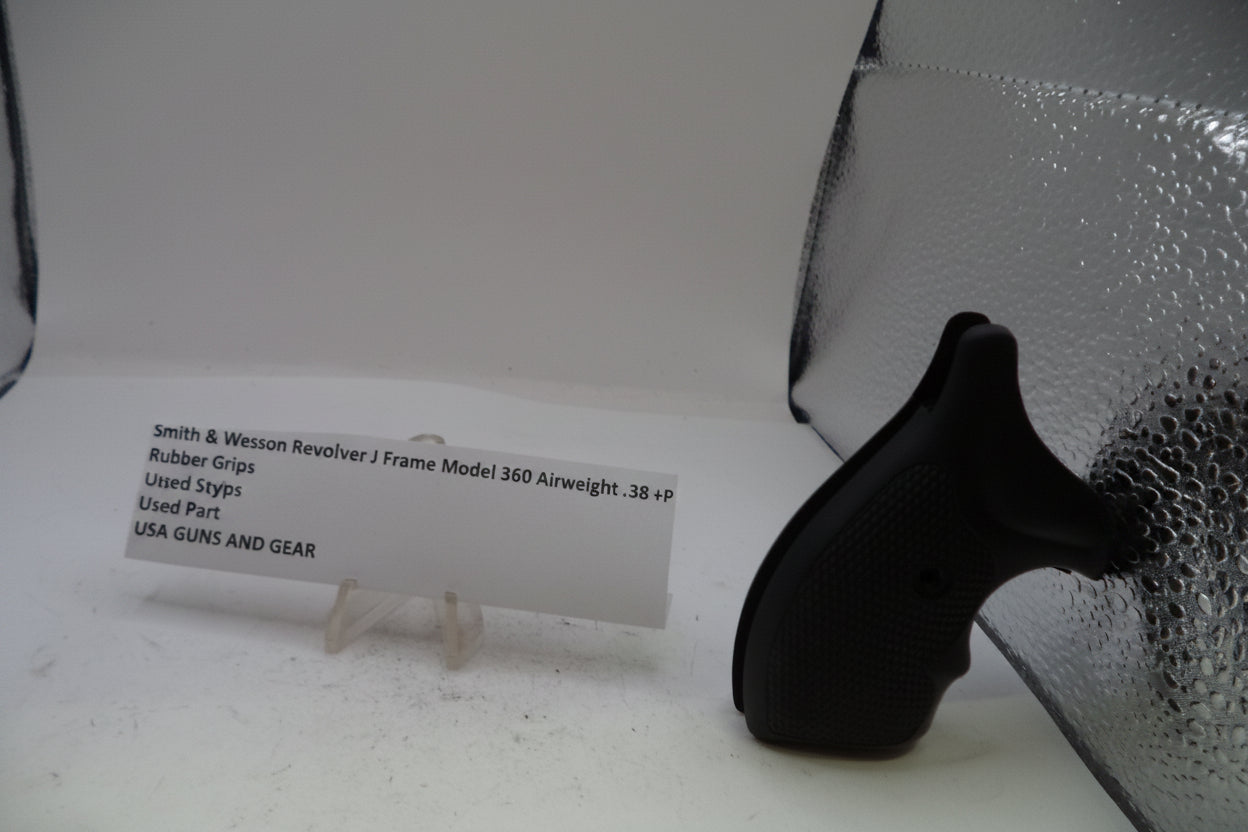 A black rubber grip replacement part for a Smith & Wesson Revolver J Frame Model 360 Airweight, displayed on a white surface next to a white product information card and a silver reflective sheet.