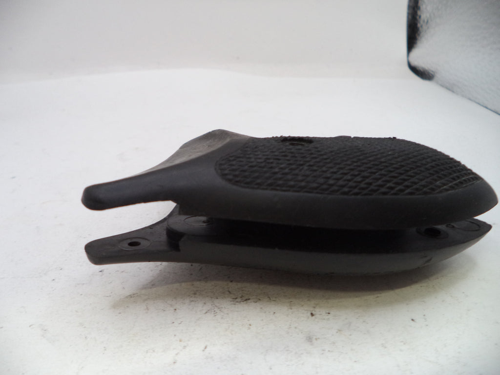 A black textured rubber or polymer accessory piece, possibly a grip or protective cover, shown on a white surface.