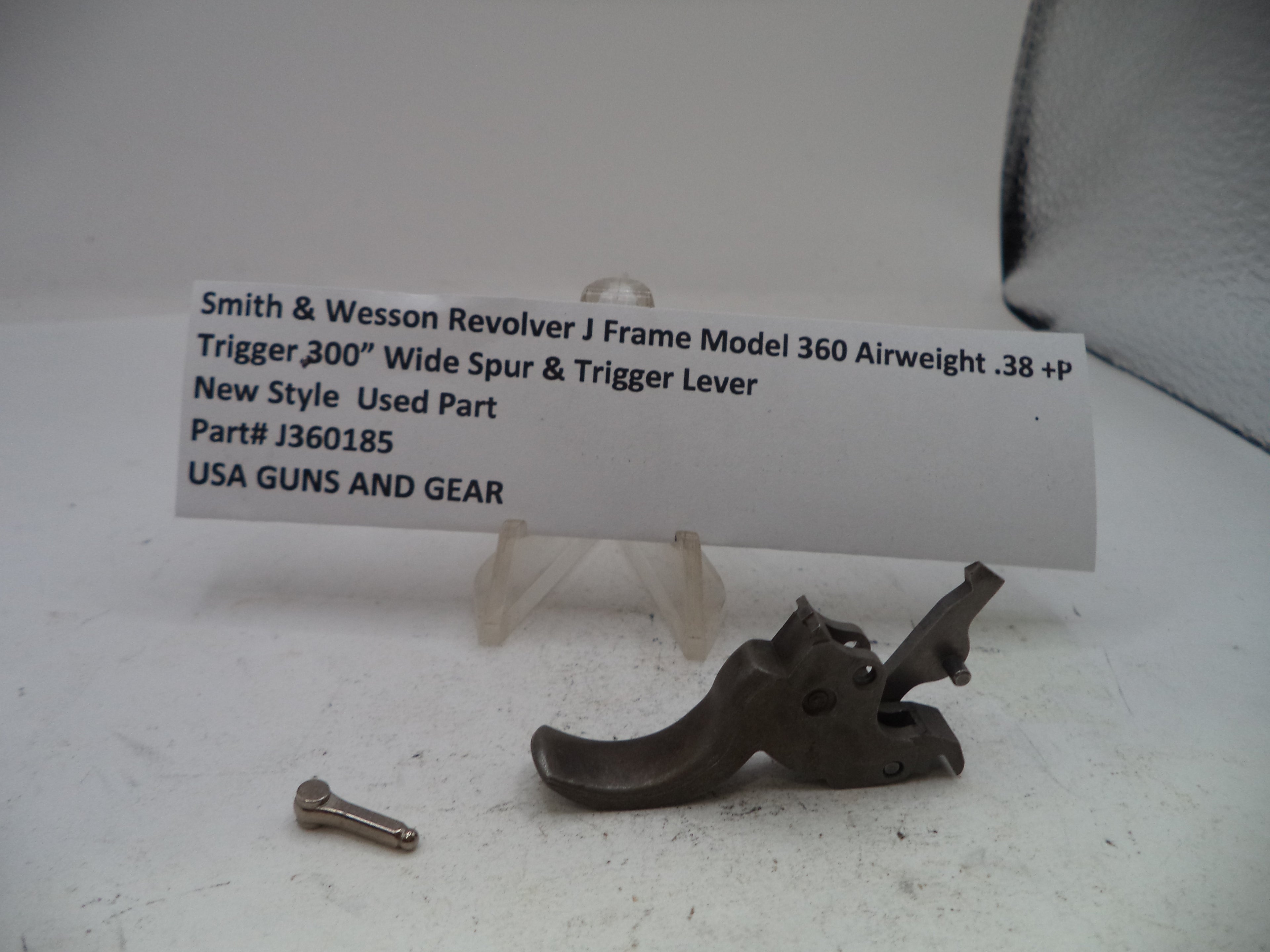 Smith & Wesson Revolver J Frame Model 360 airweight trigger lever and wide spur used part, displayed on a white surface with a product information card behind it.