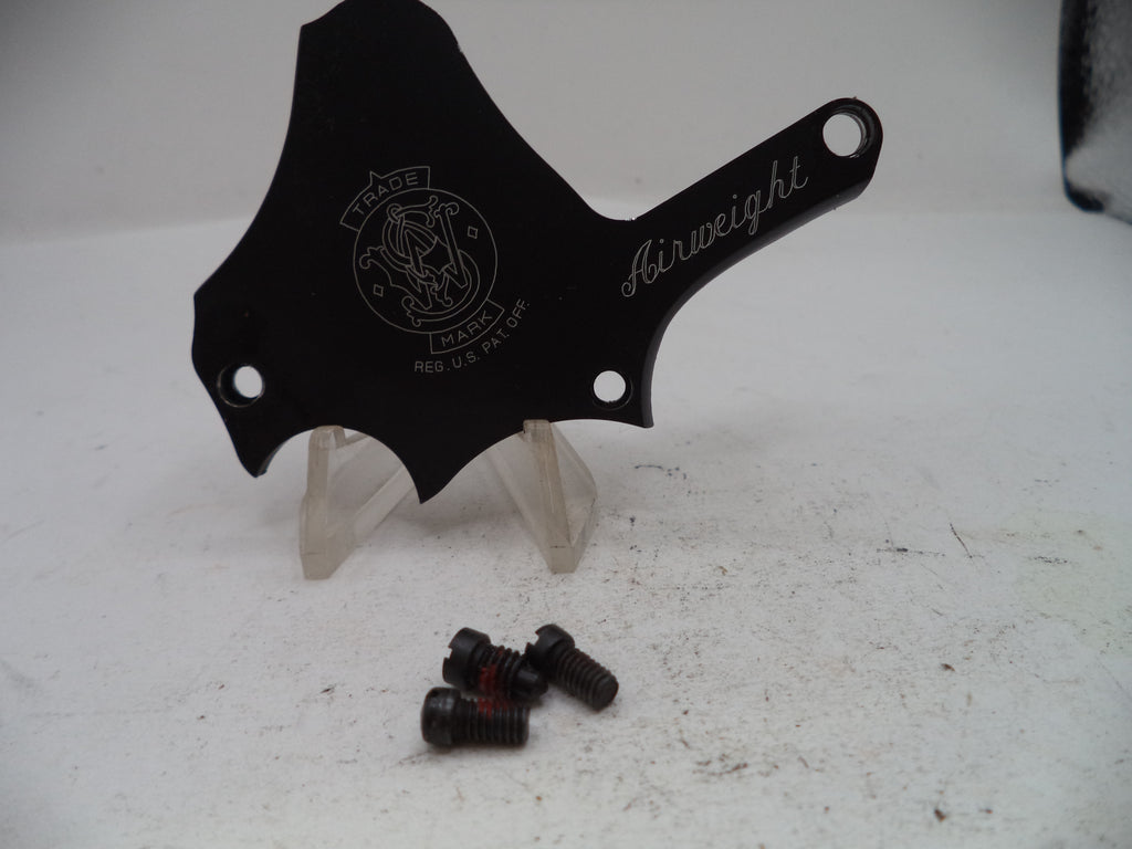 A black metal motorcycle handlebar clip or guide with 'Airweight' and a crest logo engraved, displayed on clear plastic stands with three mounting screws below on a white surface.