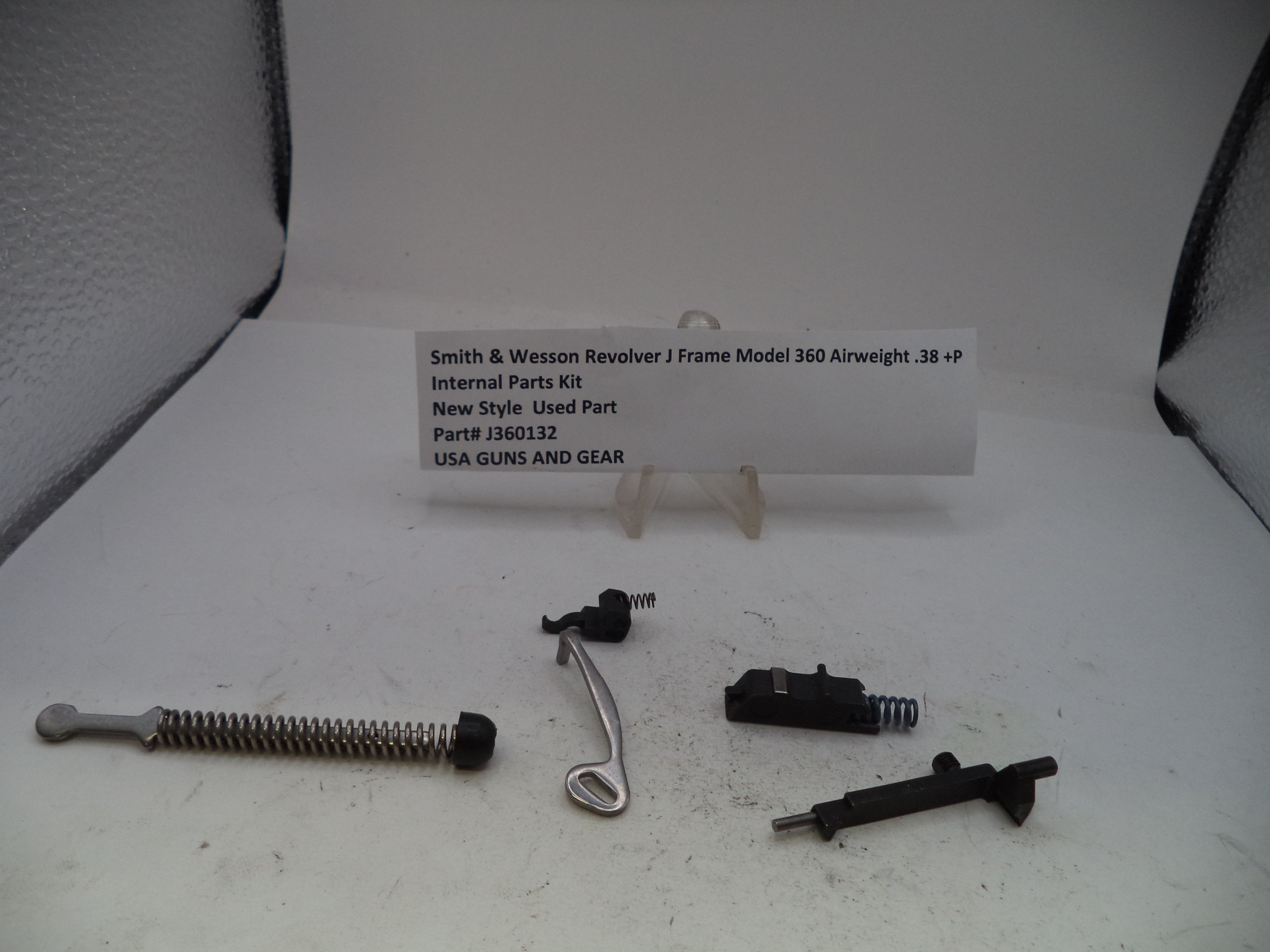 Smith & Wesson Revolver J Frame Model 360 Airweight internal parts kit, including a long silver coil spring, a curved silver metal piece, and two black metal components, displayed on a white surface with a product information card.