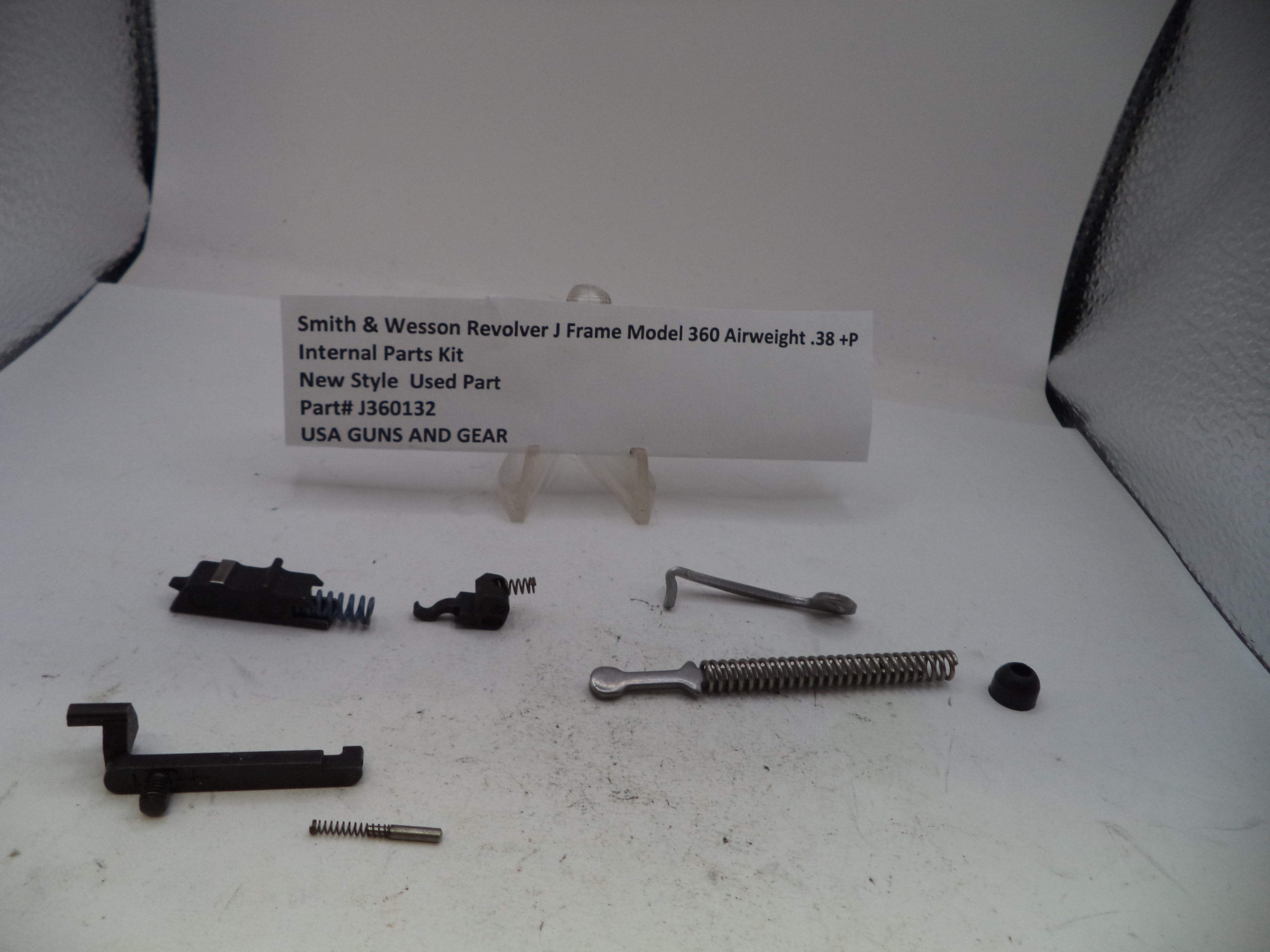 Smith & Wesson Revolver J Frame Model 360 Airweight internal parts kit, part number J360132, displayed on a white surface with a small label card. The kit contains various black and silver metal components including a spring, lever, screws, and a black receiver assembly.