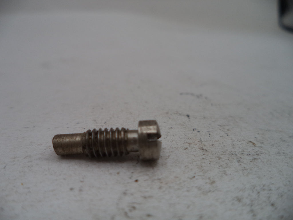 A small metal threaded screw or bolt with a slotted head, resting on a light gray textured surface.