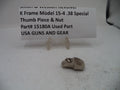 A small metal firearm thumb piece and nut replacement part, part number 15180A, displayed on a white surface in front of a white sign with black text identifying the item.