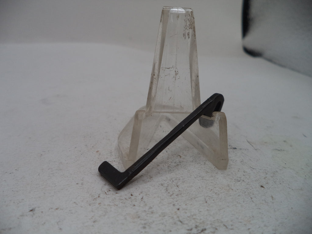 A black metal L-shaped bracket or clip displayed on a clear plastic stand against a light gray background.