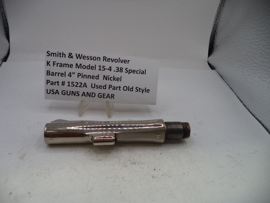 A metallic silver and dark gray Smith & Wesson revolver barrel pin, displayed on a white surface with a white identification card behind it.