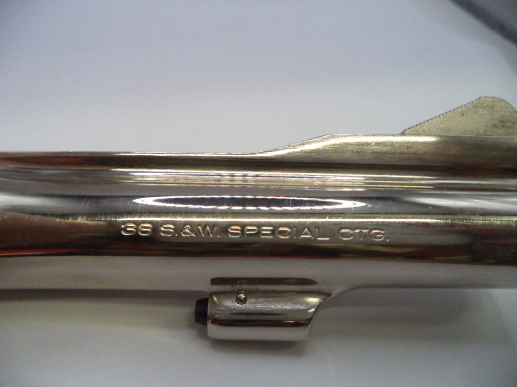 Close-up of a polished metallic cylindrical component with engraved text reading '36 S.A.