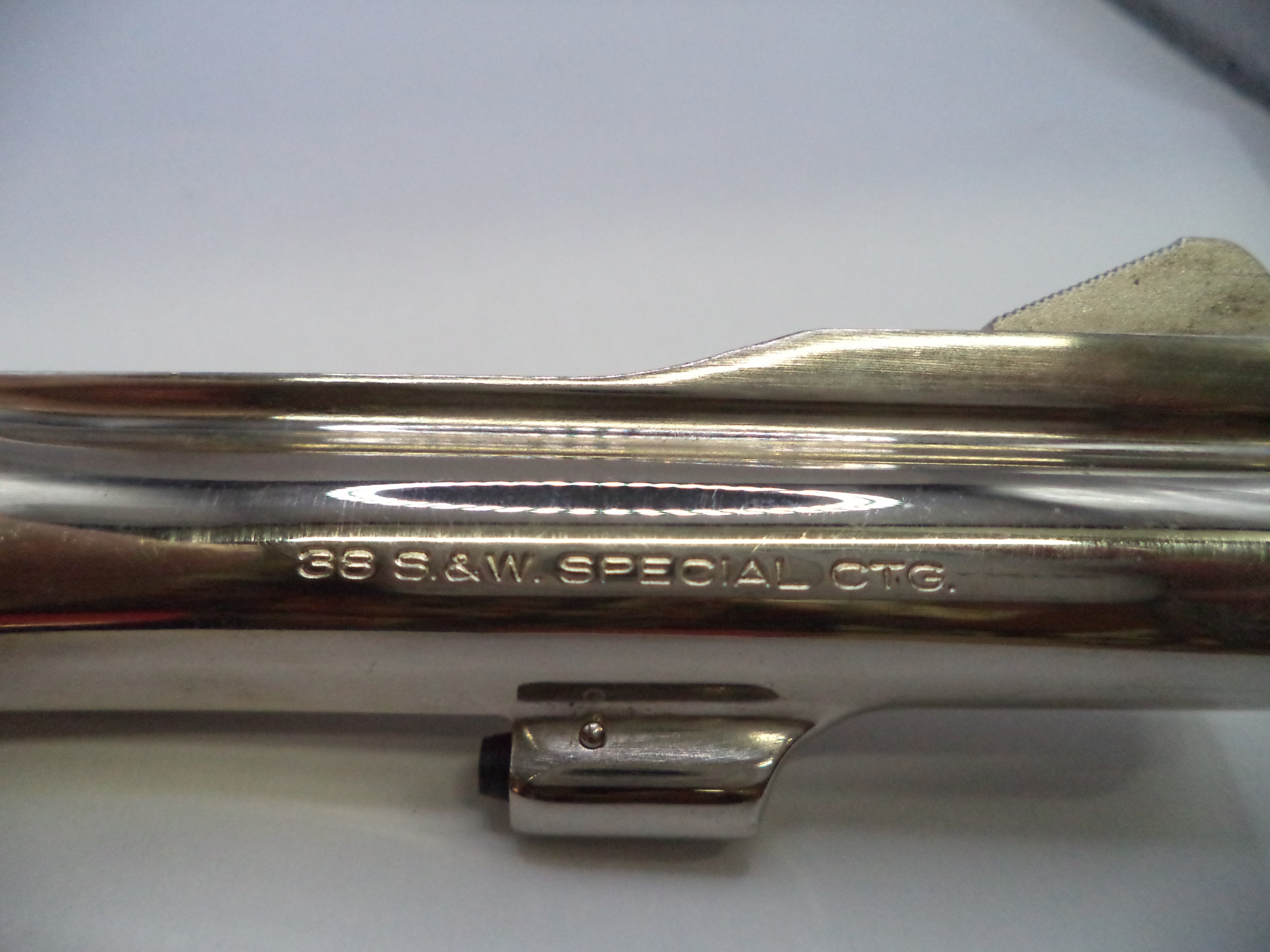 Close-up of a polished metallic cylindrical component with engraved text reading '36 S.A.