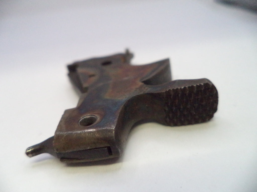 A close-up of a dark brown textured metal object, possibly a mechanical part or tool component, on a plain white background.
