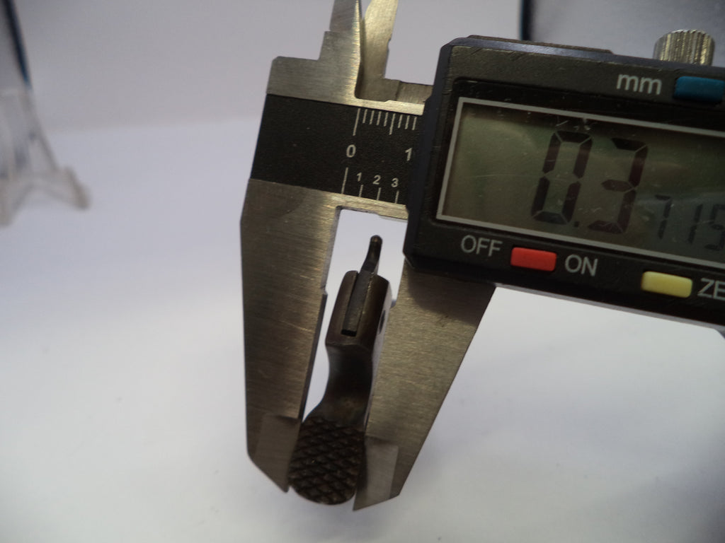 A close-up of a digital caliper measuring the thickness of a small black textured ring or gasket, with the display reading 3.15 mm.
