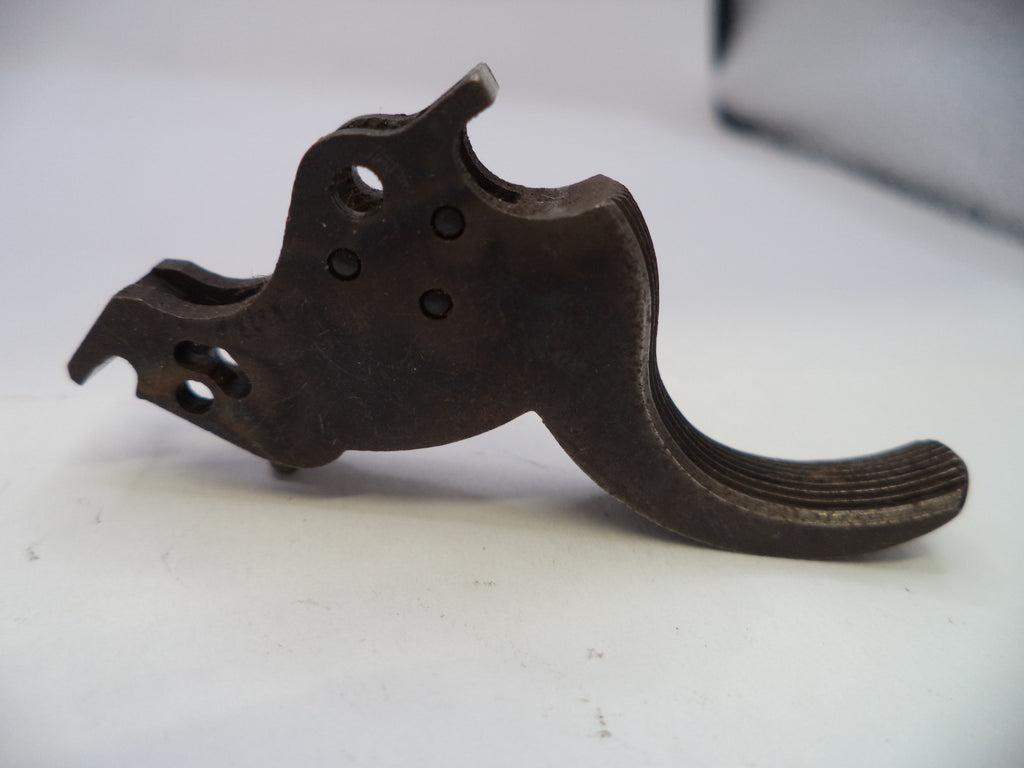 A dark brown metal trigger switch component with a textured, aged finish, photographed on a plain white surface.