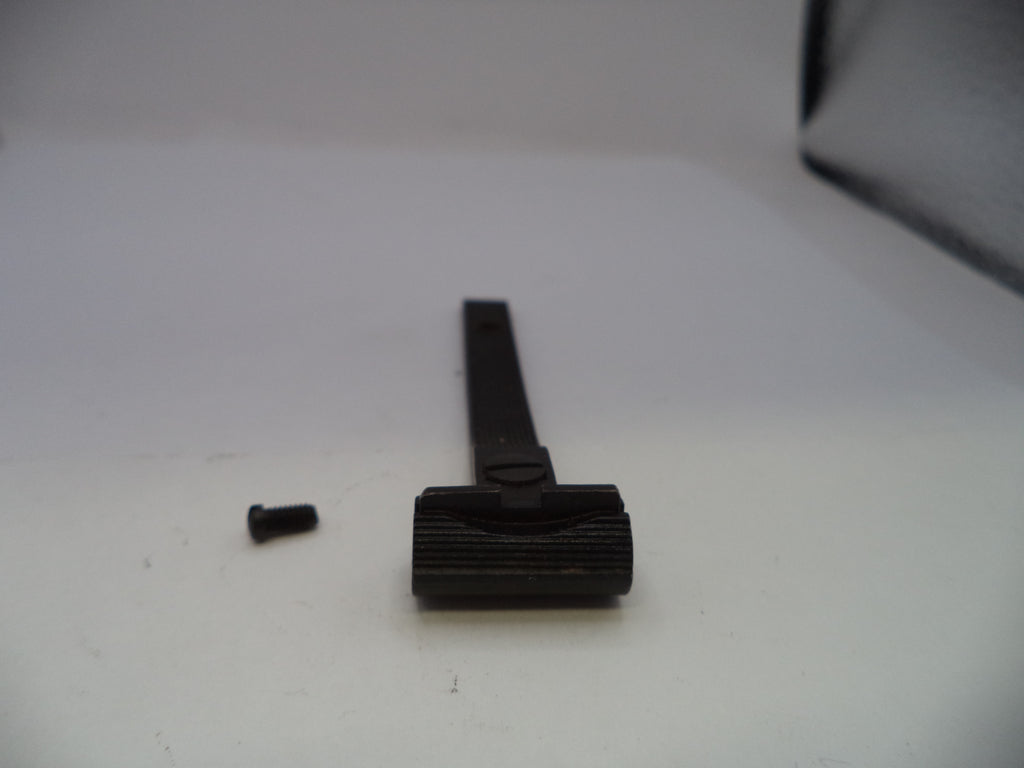 A black plastic or metal razor handle with a textured grip and a small detached screw, photographed on a plain light background.