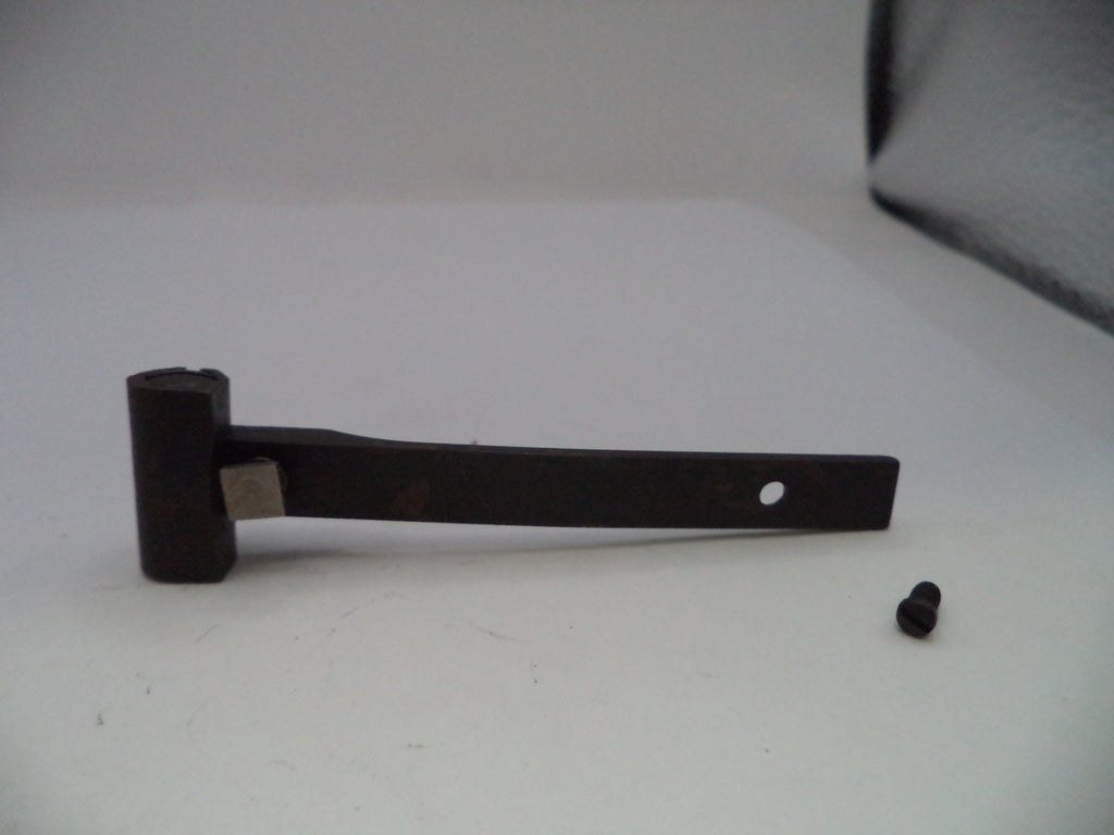 A dark metal hinge or bracket with a small mounting screw placed beside it on a plain light background.