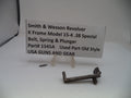 A used metal bolt, spring, and plunger part for a Smith & Wesson revolver, displayed on a white surface with a small sign identifying the part and model.