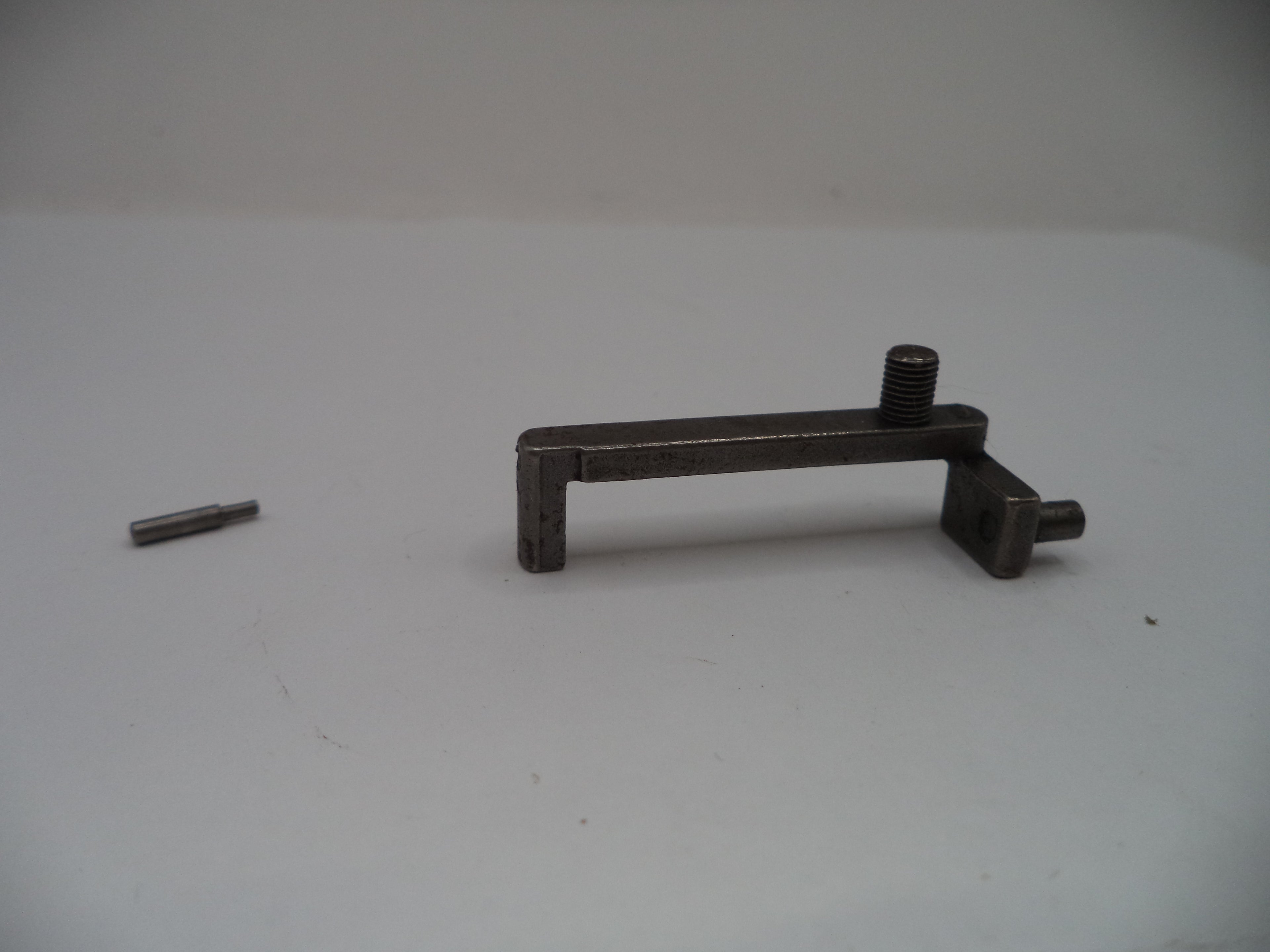 A dark metal mounting bracket with a threaded screw post and a small matching pin, shown on a plain light gray background.