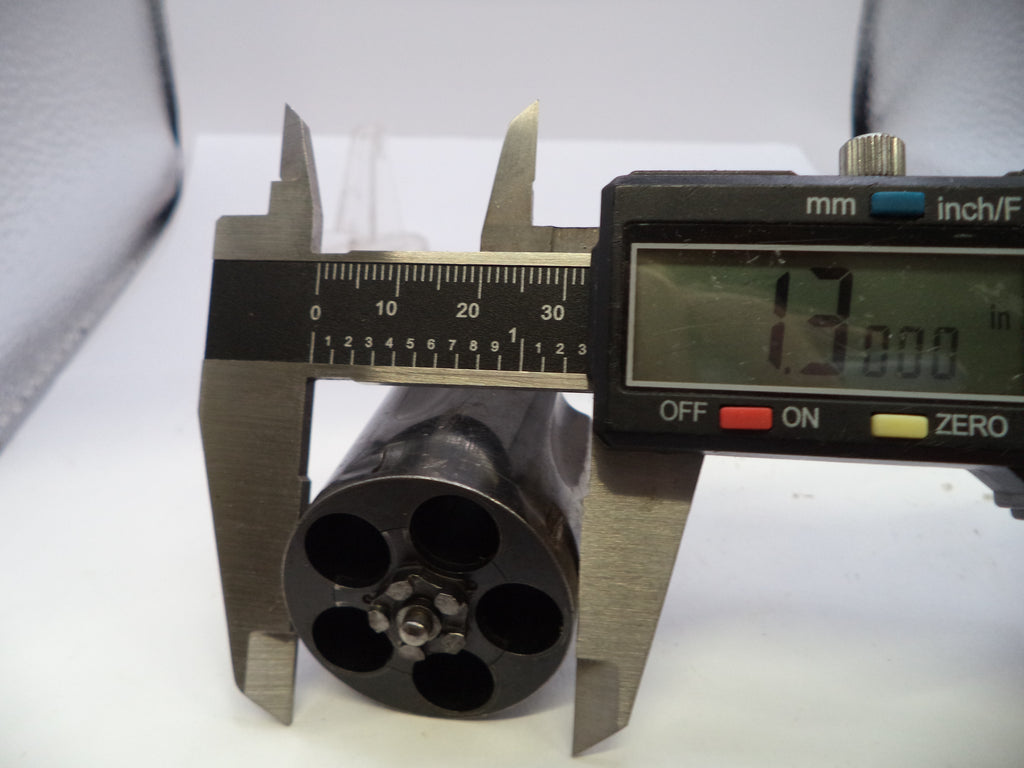 A close-up of a black cylindrical product with a six-hole pattern, measured by a digital caliper showing 12.000 mm.