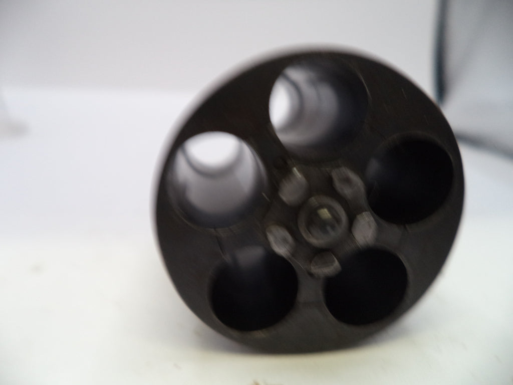 A close-up of a black plastic multi-portable container or cup with five circular openings, photographed on a white surface.