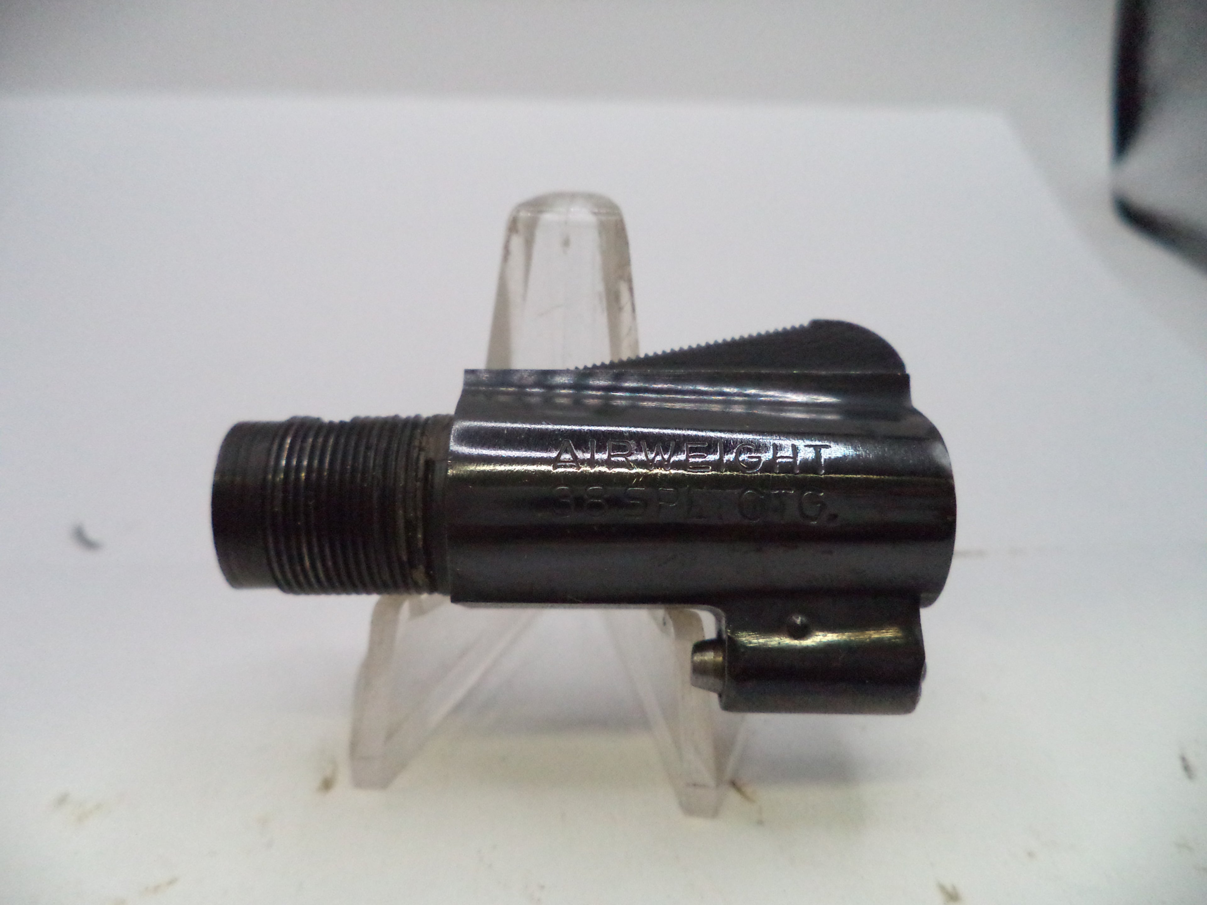 A black metal mechanical component, likely a firearm magazine or receiver part, with 'NORUM' and '3541 C16' stamped on its side, displayed on a clear plastic stand against a white background.