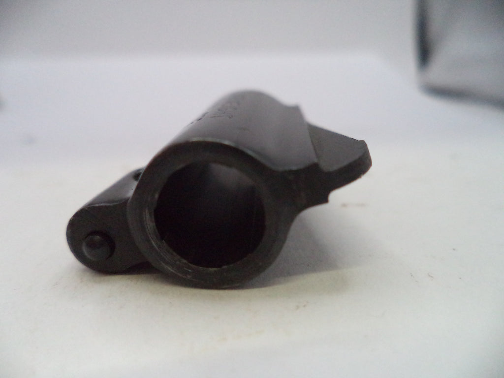 A close-up of a black metal cylindrical component or hardware part on a white surface.