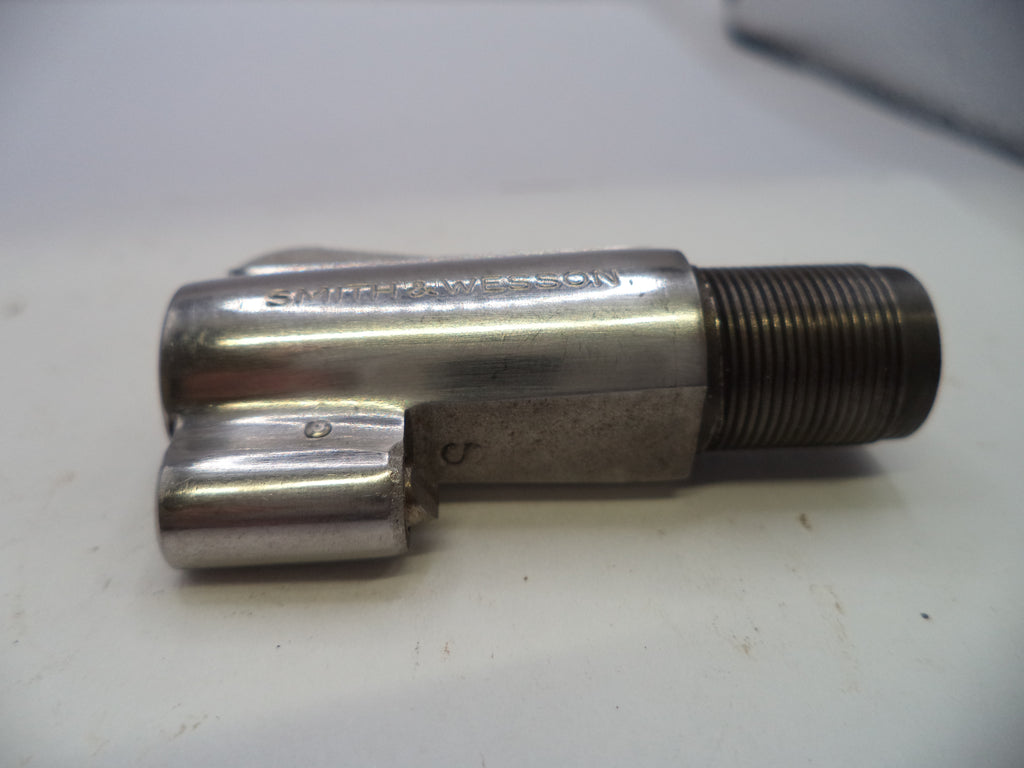 A used metallic bicycle headset component with a threaded bearing race, resting on a white surface.