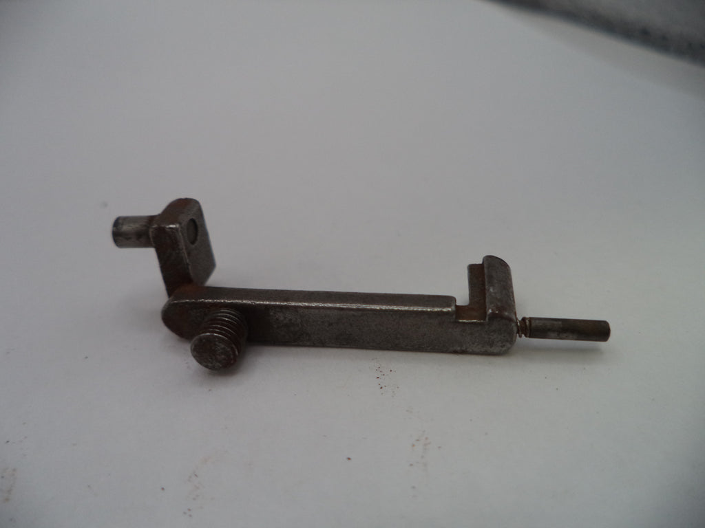 A small metal mechanical component or latch with a threaded screw and a flat shaft, photographed on a plain light background.
