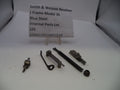 Internal parts lot for a Smith & Wesson Revolver J Frame Model 36 in blue steel, containing various metal components and springs, displayed on a white surface with a paper label in the background.