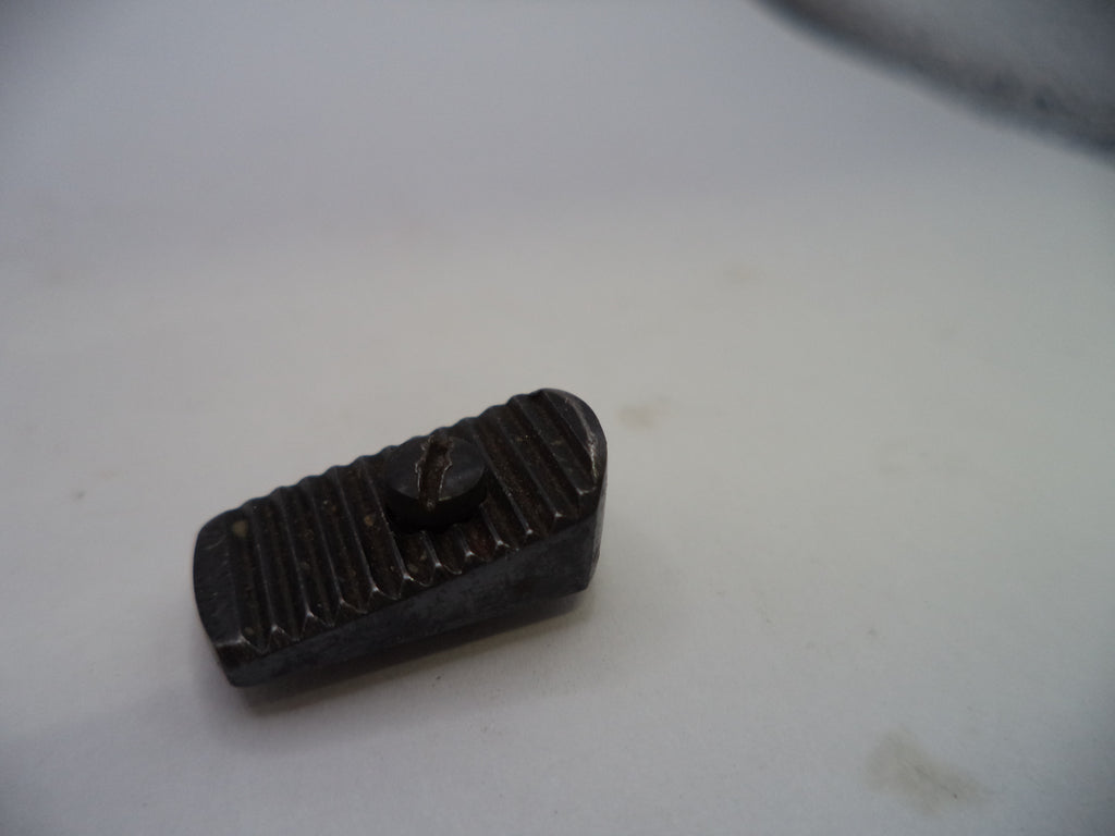 A small dark metal or plastic rectangular component with a ribbed top surface and a small protruding tab, photographed on a plain light background.