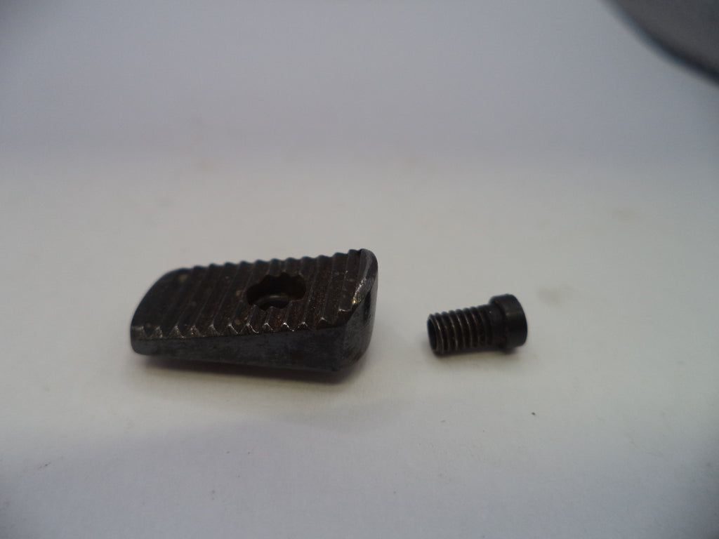 A small black metal adjustment block with a textured surface and a central hole, shown next to a matching black threaded screw on a plain light background.