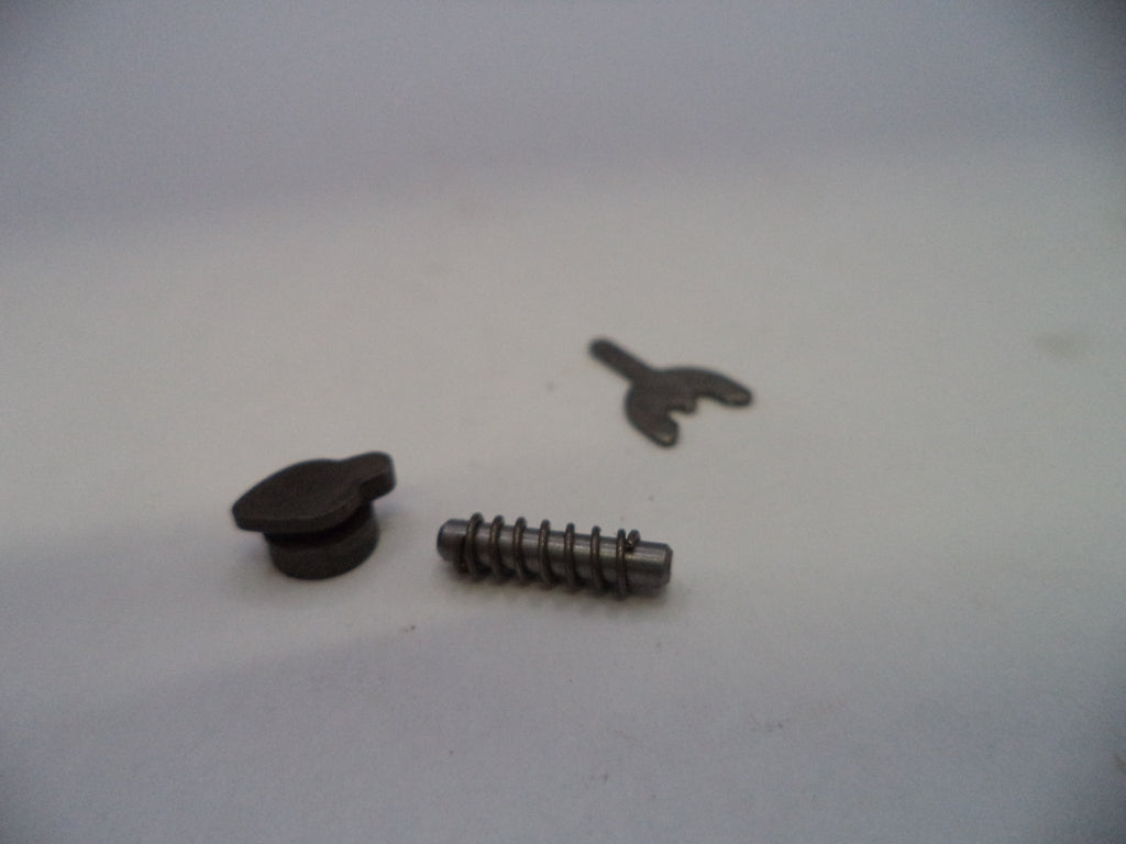 A small metal hardware set consisting of a dark metal snap button, a silver metal screw pin, and a small metal clip, displayed on a plain light gray surface.